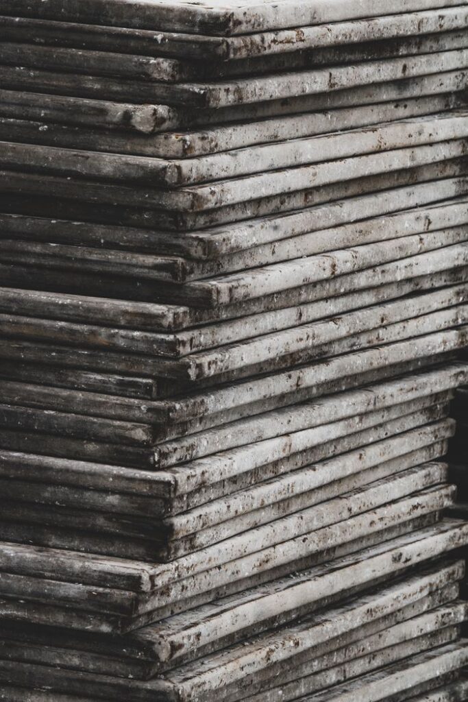 A vertical stack of rough, weathered concrete slabs showcasing an industrial texture.